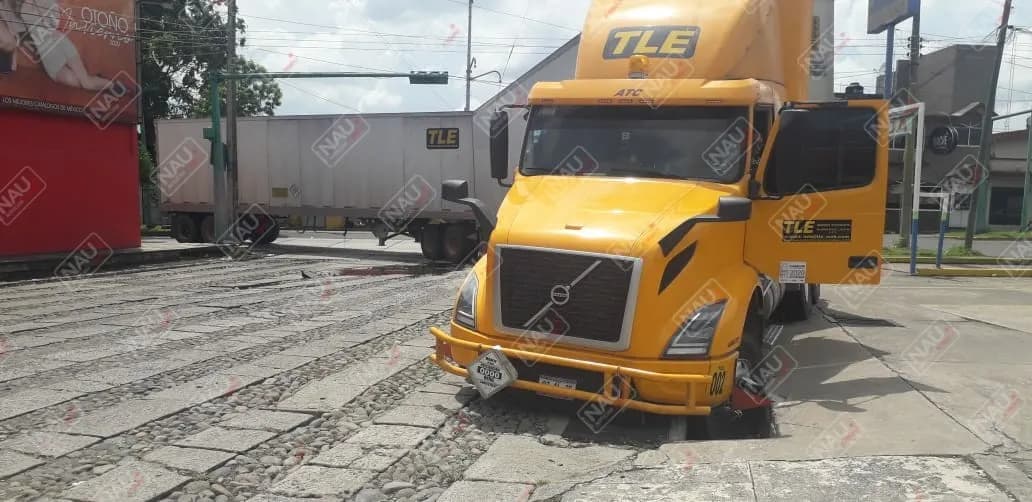 Un tráiler y un camión de agua cristal se hundieron en el pavimento