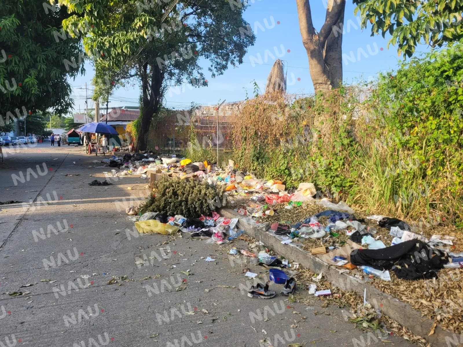 Acusan a vendedores haitianos de tirar basura frente a un conjunto habitacional
